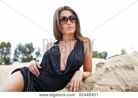 A beautifull caucasian girl lying on the sand,