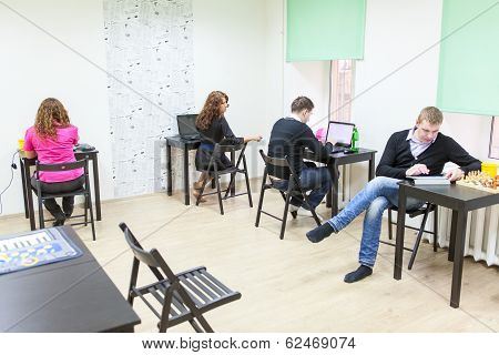 Young Adults Surfing Internet In Co-working Room