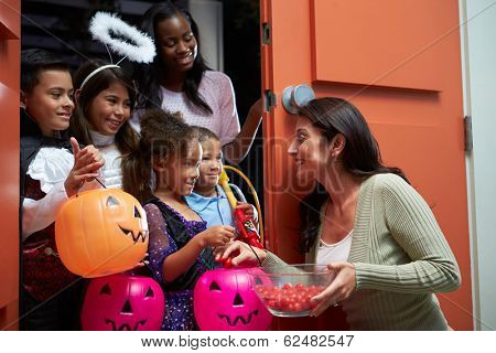 Children Going Trick Or Treating With Mother