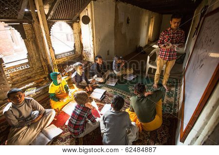 KATHMANDU, NEPAL - DEC 9, 2013: Unknown children in lesson at Jagadguru School. School established at 2013, to let new generation learn Sanskrit and preserve Hindu culture. 
