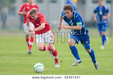 TRAISKIRCHEN, AUSTRIA - JUNE 5  Lukas Jaeger (#3 Austria) and Armin Cerimagic (#11 Bosnia and Herzegovina) fight for the ball during the U19 game on June 5, 2013 in Traiskirchen, Austria.