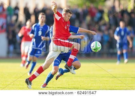 TRAISKIRCHEN, AUSTRIA - JUNE 5 Lukas Jaeger (#3 Austria) and Mirko Maric (#8 Bosnia and Herzegovina) fight for the ball during the U19 game on June 5, 2013 in Traiskirchen, Austria.