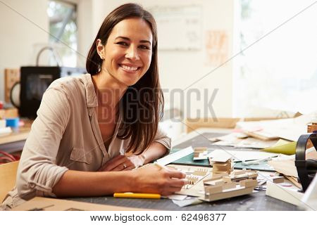 Female Architect Making Model In Office