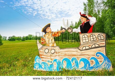 Two pirates dueling with swords on ship