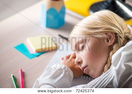 Sleeping school girl in classroom