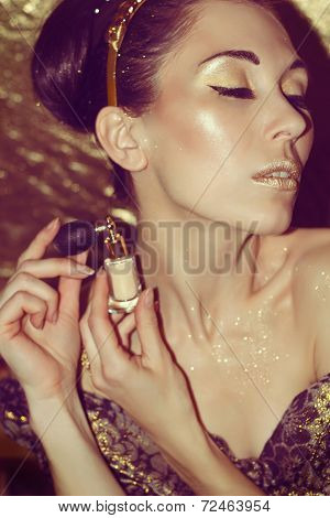 Portrait Of Young Woman With Gold Makeup