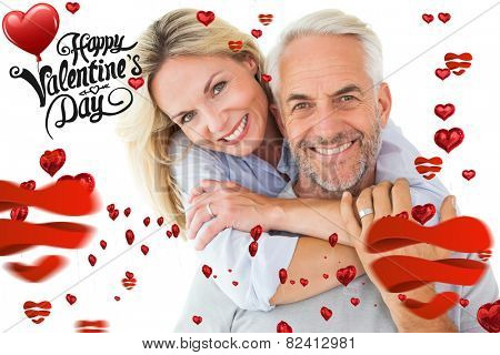 Happy couple standing and hugging against cute valentines message