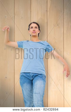 Powerless brunette against bleached wooden planks background