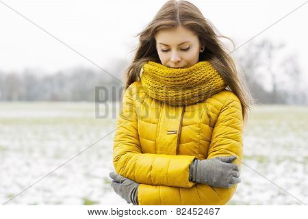 Pretty Woman In A Yellow Knit Scarf And Yellow Jacket. Outdoors Portrait In The Park.