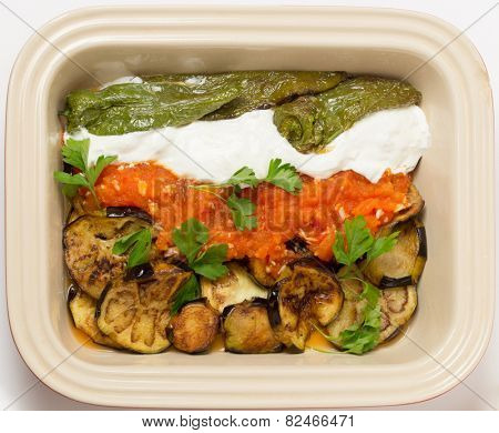 Fried aubergine (or eggplant) and fried mild green peppers served with garlic infused tomato and yogurt sauces. This is a traditional Turkish summer dish, served cold.