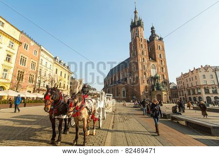 KRAKOW, POLAND - FEB 7, 2015: St. Mary's Church in historical center of Krakow on Main Square - dates to the 13th century, and at roughly 40,000 m it is the largest medieval town square in Europe.