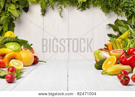 frame with fresh organic vegetables and fruits on wooden background