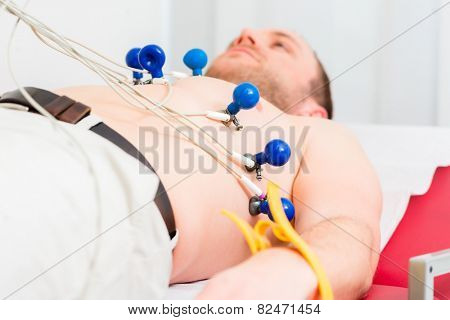 Male patient having ECG electrocardiogram in hospital