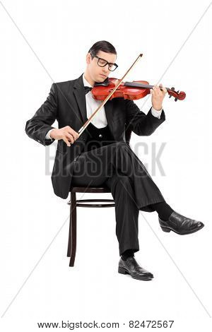 Studio shot of a classical musician playing violin seated on chair isolated on white background
