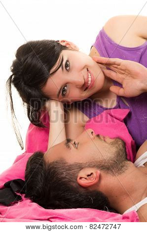 cute loving couple lying in bed wearing pijamas