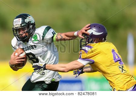 VIENNA, AUSTRIA - JULY 14 QB Jonathan Dally (#8 Dragons) and DB Benjamin Bubik (#4 Vikings) fight for the ball at the playoffs of the AFL on July 14, 2013 in Vienna, Austria.