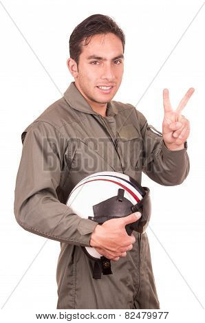 young male hispanic pilot holding helmet