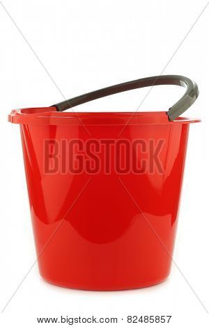 empty red plastic household bucket with a grey handle on a white background