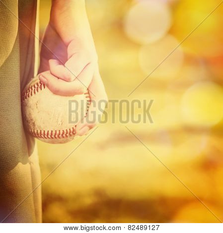 Boy holding a baseball ready to pitch.  Instagram effect.