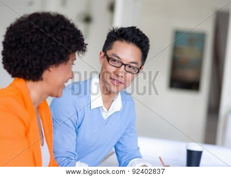 Two desingers working on a project together in office
