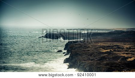 seawaves on a rocky shore at magnificent dusk