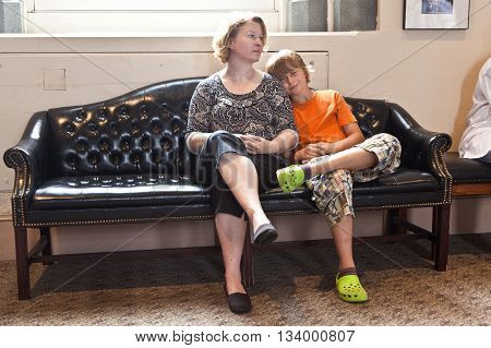 Mother And Son Sitting On A Bench