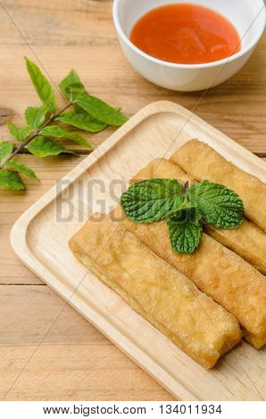 Fried Tofu In Wooden Plate With Sauce On Wooden Background