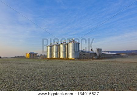Silos In The Middle Of A Field In Wintertime