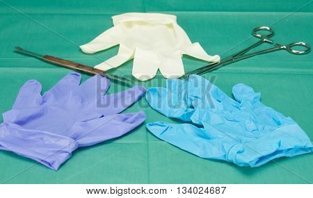 Three Pieces Of Gloves And Surgical Equipment