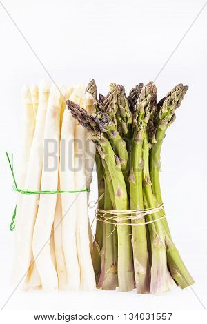 heap of green and white asparagus vegetables isolated on white background.