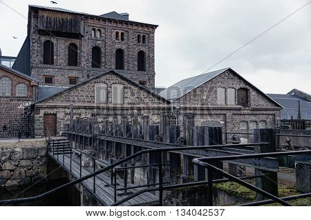 Old Swedish ironworks with water dam in front.