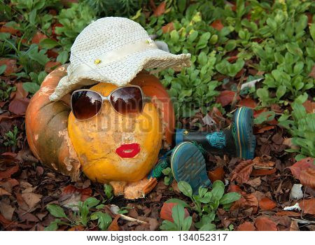 Pumpkin in pumpkin patch dressed up in lady's clothes