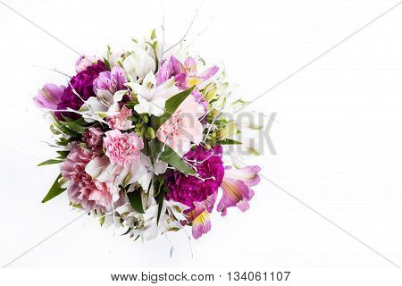 Bouquet from pink and purple gillyflowers and alstroemeria on white background