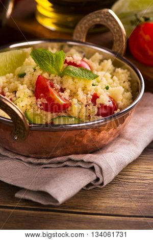 Oriental couscous salad tabouli, selective focus. Closeup