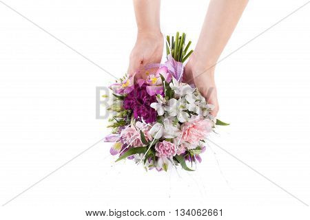 Hands holding a summer bouquet from pink and purple gillyflowers and alstroemeria
