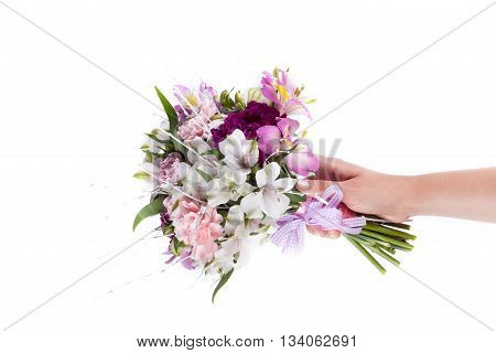 Hand holding a pink bouquet from gillyflowers and alstroemeria