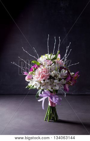 Pink bouquet from gillyflowers and white alstroemeria on blackboard
