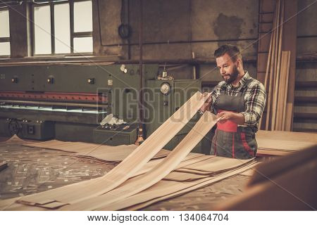 Carpenter doing his job in carpentry workshop.
