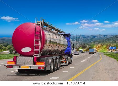 Tanker with chrome tanker on the highway. Working visit