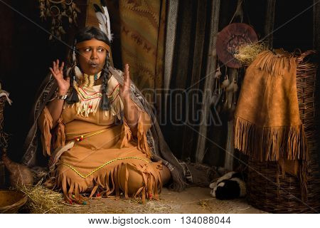 Weathered mature tribal female storyteller talking about heroic times