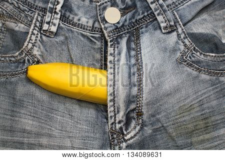 banana fruit in condom inside jeans pants contraceptive concept