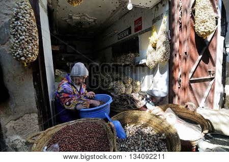 FES - MARCH 10: Unknown man trades a snails in a Market (souk) in a city Fes in Morocco. The market is one of the most important attractions of the city. March 10, 2012 Fes, Morocco.