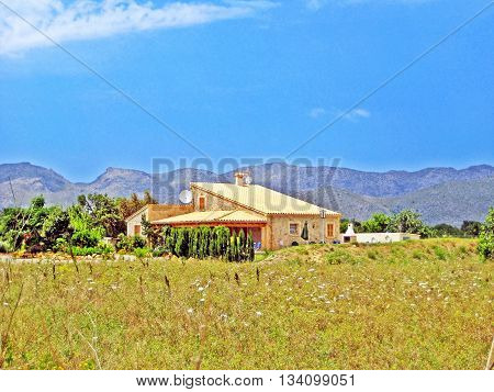 Majorca Spain - June 28 2008: Finca / rural country home - tramuntana mountains in the background meadow in front