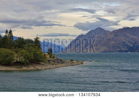 andscape in Central Otago New Zealand. Lake Hawea forest and mountains.