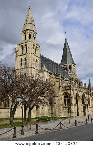 Poissy France - april 4 2016 : the picturesque collegiate church in spring
