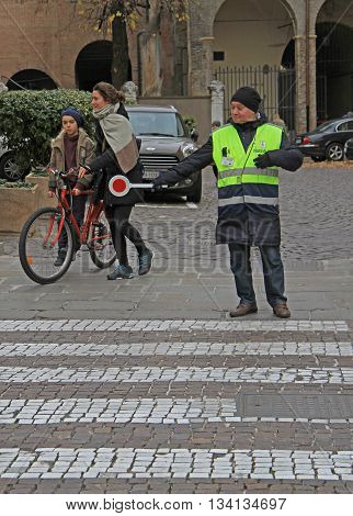 Traffic Controller Is Helping To People On Pedestrian Crossing In Padua, Italy
