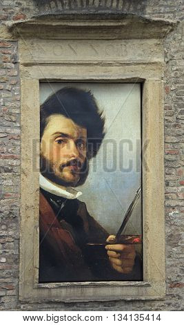 Padua Italy - November 25 2015: wall of museum with portrait of Giovanni Fattori in window Padua in Italy