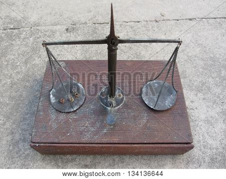 Vintage handmade balance scale with hunting cartridge primers on the left plate