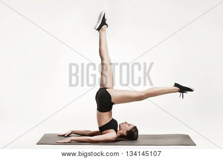 Portrait of young attractive woman doing exercises. Brunette with fit body on yoga mat. Healthy lifestyle and sports concept. Series of exercise poses.