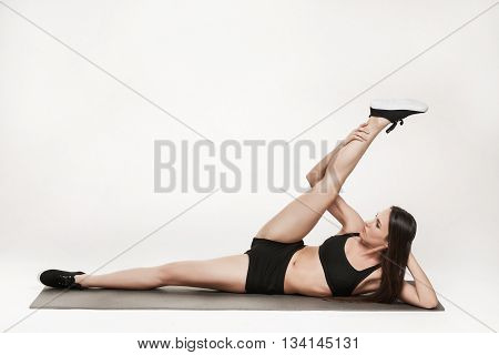 Portrait of young attractive woman doing exercises. Brunette with fit body on yoga mat. Healthy lifestyle and sports concept. Series of exercise poses.